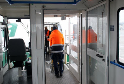 Passenger helped boarding a plane from the ambulift